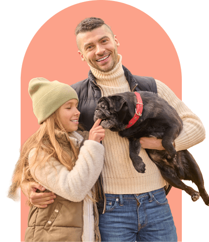 A man and a girl playing with a dog